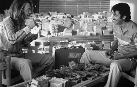 George Jung (Johnny Depp), left, and Diego (Jordi Molla) sit in their apartment surrounded by their ill-gotten gains.