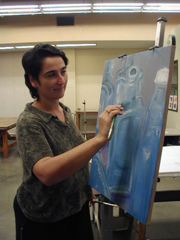 GCC student, Susie Goliti puts on the finishing touches to a recent piece.