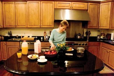 Coleman prepares a meal in her kitchen at home.