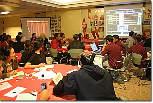 ASGCC members Arach Orujyan and Paolo Banaag, center with laptop computer, keep track of clubs points and determine which team buzzed in first at the inaugural academic decathlon on Nov. 18.	