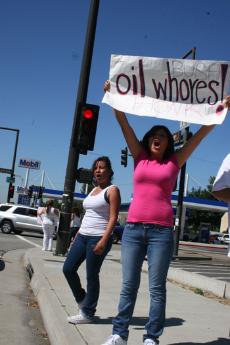 Fatima Casta¤eda, left, and Yajira Cervantes participate in the May 7 protest, actively encouraging passing cars to honk in support.