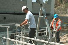 Rental equipment vendors, Jim Finnie, left, and Paul Ortega assemble scaffolding to be used on the new parking structure construction site.