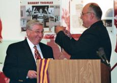 Gary Wright, left, receives the Pillar of Achievement from Director of Sports Information Alex Leon at the Athletic Hall of Fame on Mar 8.