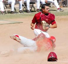 Vaquero catcher, Jose Mendieta, takes action into his own hands and outs base runner Travis Morgan, 20, during the April 12 game against Bakersfield. 