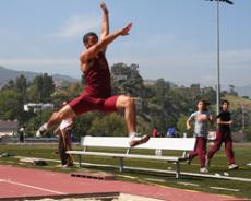 David Nalbanyan runs and leaps for a score in the long jump.