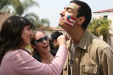 Conservative Club member Melissa Cassara paints her team mate Sevada Amirian's face, while getting cheered on by fellow club member at the IOC Olympics in Plaza Vaquero.