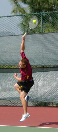 Ryan Stanbury, 19, jumps to return a serve.