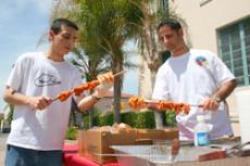 Sevak Shakhabandarian, 26, right, and Armen Manuk-khaloyan, 21,  prepare shish kabobs for the Armenian Culture Day event in Plaza Vaquero on May 15. Shish kabobs were one of various entrées that came with the eight dollar meal.