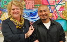 KEEPING IT REAL: Art Professor Caryl St. Ama, above left, and artist Manny Bracamonte are seen in front of his painting Friday in the cafeteria.