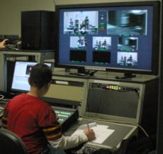 Jose Robleto checks video monitors while filming "High School Confinement,"  directed by Weber and shot at the GCCTV studios. 