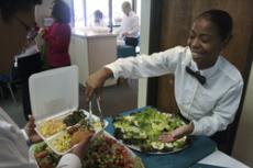 Hospitality management major Yana Johnson helps serve food