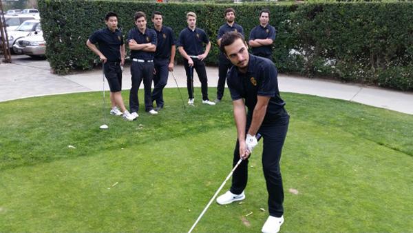 TOP GOLFER: Tavit Garbarian swings through a drive off the tee at a recent practice as his Vaquero teammates look on.