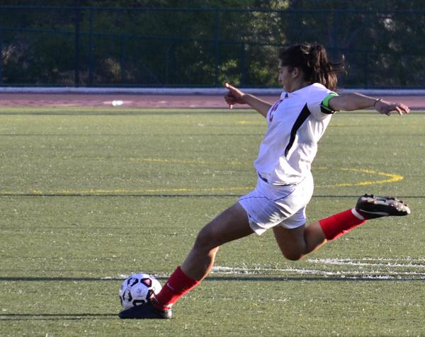 Forward Jackelyn Alarcon crosses the ball at Sartoris Field on Sept. 18. Despite her effort, the Lady Vaqs lost the game 1-0.