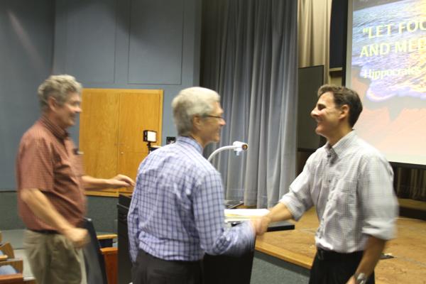 FACULTY AWARD: President David Viar congratulates biology professor Joseph Beeman, recipient of the 28th Annual Distinguished Faculty Award, after his presentation, “Blissful Eating, Compulsive Thinking: The Body-Brain Connection” in Kreider Hall Thursday.