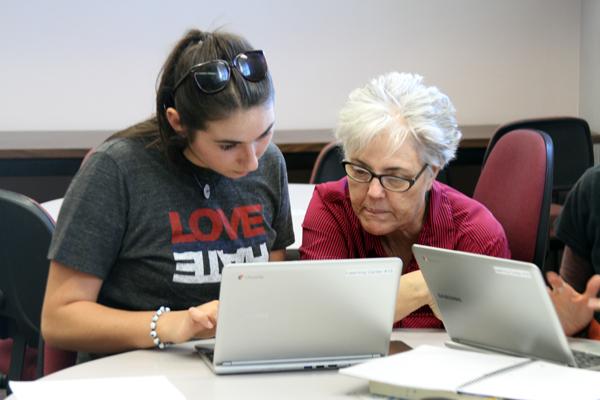 STUDY HALL PLUS:  Lynn Woods helps Christine Guarino with her writing in the Learning Center’s new study hall on Oct. 29.