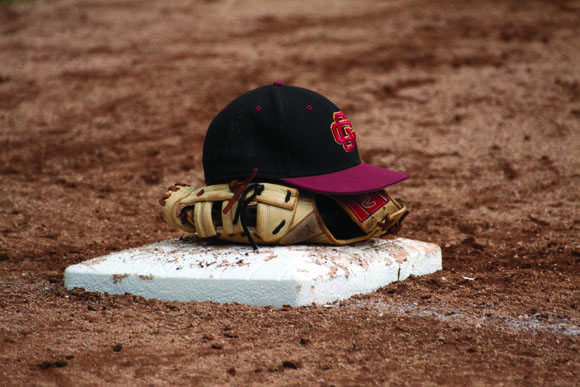 IT’S ALL OVER: A Vaquero placed his hat and glove on first base after losing to Fullerton College in the first round of the SoCal Regional playoffs.