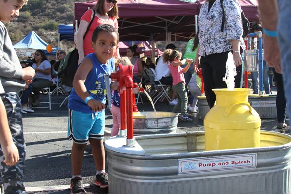 COOLING OFF:
  Elijah Sowers, 3, enjoys the 
  water splash at the Parent/Student Association’s Harvest Hoedown in the upper campus parking lot on Saturday.