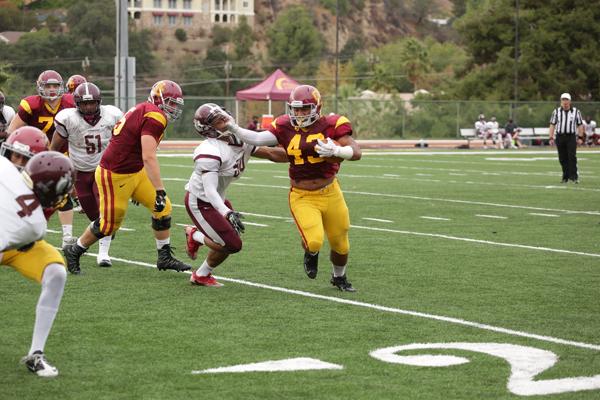 BREAKING TACKLES: Vaqueros running back Ioane Muipulusu crushes a Warrior in the last home game of the season at Sartoris field. 