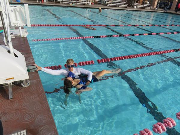 AFLOAT: Dr. Lee Parks supports student Zoe Johnson during their adapted aquatics class at the Rose Bowl Aquatics Center in Pasadena.