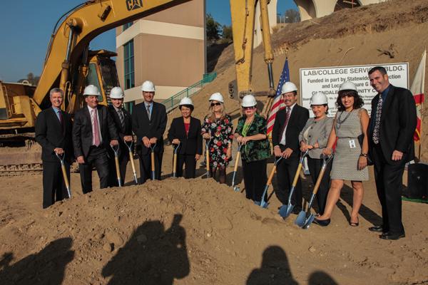 BREAKING GROUND: College dignitaries and city officials donned hard hats, and grabbed shovels at the ground breaking for the Sierra Vista building on Oct. 21, 2013. Now more than three years later, the structure is still not complete.