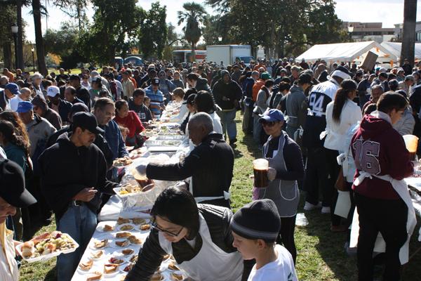 VOLUNTEERS: Union Station Homeless Services feed the hungry and less fortunate at the annual Dinner in the Park in Pasadena. 