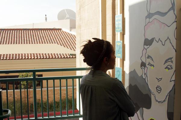 MURAL MURAL: Artist Jennifer Gurantz faces her interactive mural located outside the Aviation Arts building