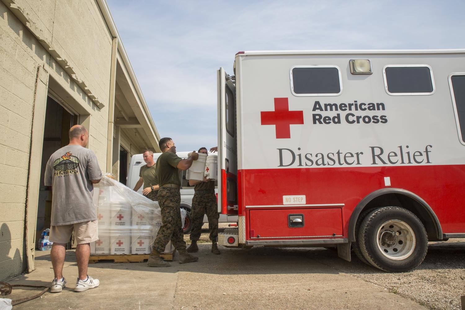 Marines from 14th Marine Regiment, 4th Marine Division, Marine Forces Reserve, load buckets of Red Cross cleaning supplies onto an American Red Cross Disaster Relief Van at Red Cross warehouse in Beaumont, Texas, Sept. 3, 2017.