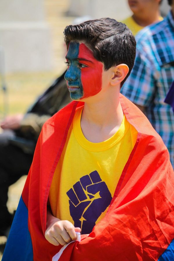 David Serobyan, 13-years-old, looks toward the crowd of protesters at the 103rd anniversary of the Armenian genocide.