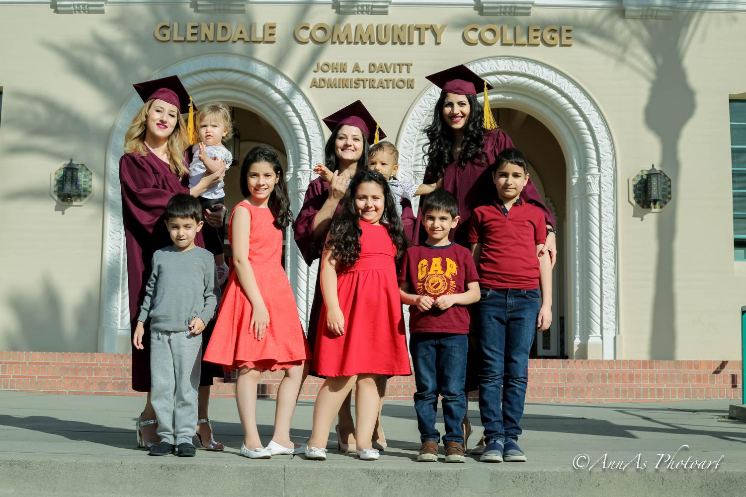 Three graduating mothers pose with their kids. From left to right: Tamara Gregoryan, Armine Sahakyan, and Anna Sargsyan.