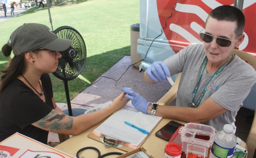 Technician Jackie Baca- Geary from the Huntington Hospital checks student Maja Herrera’s Iron level, blood pressure, pulse, and temperature to see if she qualifies as a candidate to donate blood. The blood drive was located in the quad of Glendale Community College in Glendale, Calif. 