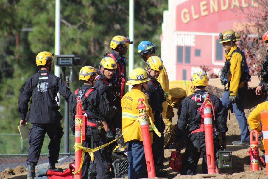 Paramedics and fire officials give medical attention to injured workers on Nov. 15.