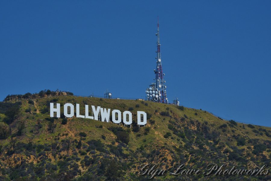 HOLLYWOOD SIGN:  The  Hollywood Sign (formerly the Hollywoodland Sign) is a landmark and American cultural icon located in Los Angeles, California. It is situated on Mount Lee in the Hollywood Hills area of the Santa Monica Mountains. 
