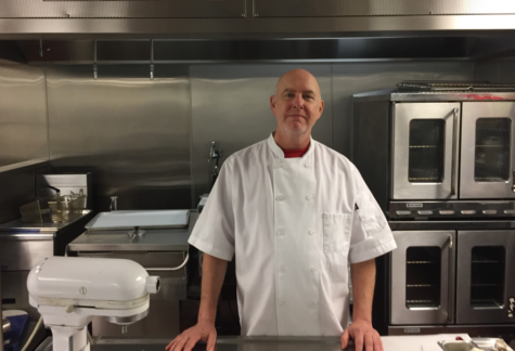 Andrew Feldman poses in a kitchen.